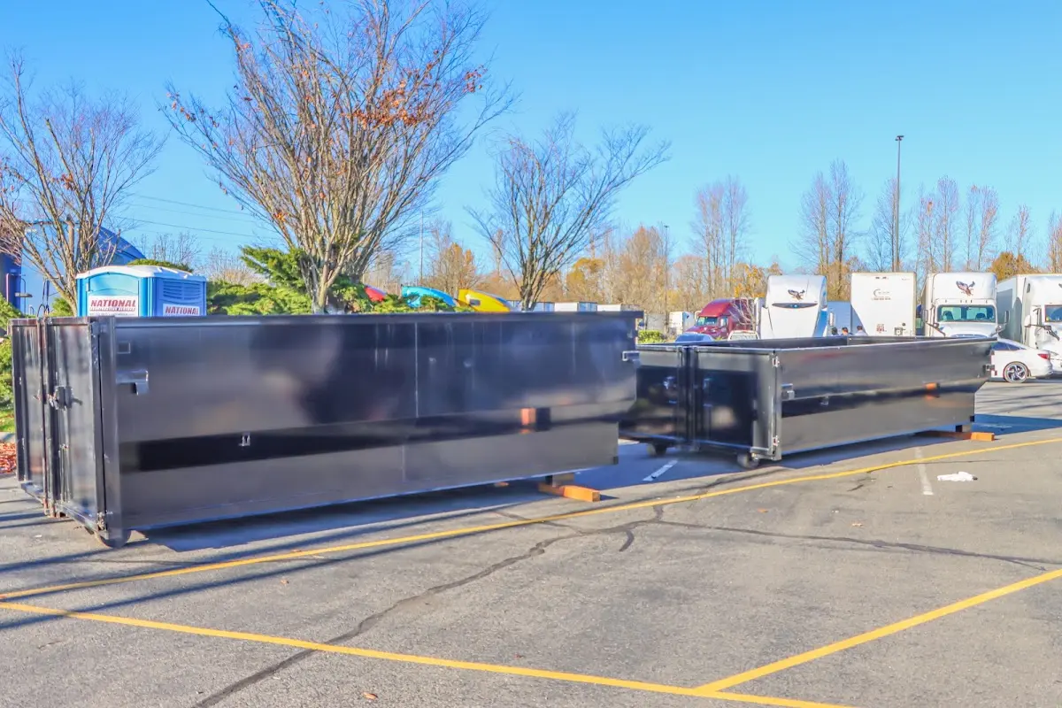 Professional dumpster rental service with roll-off container on residential driveway in Abingdon